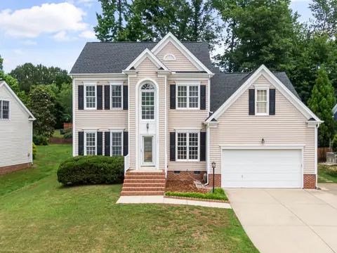 A two-storey house with a double garage and driveway on a green street in Apex, NC