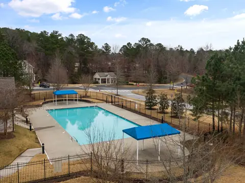 A neighbourhood pool among pines and houses in Morrisville, NC, seen from above